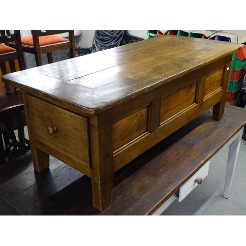 1629 - A rectangular elm coffee table with end frieze drawer, L135cm, H50cm