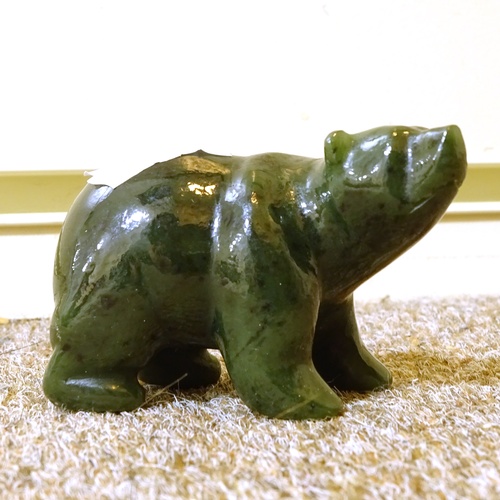 489 - A Carved and Polished Jade Polar Bear, signed TH, length 7cm