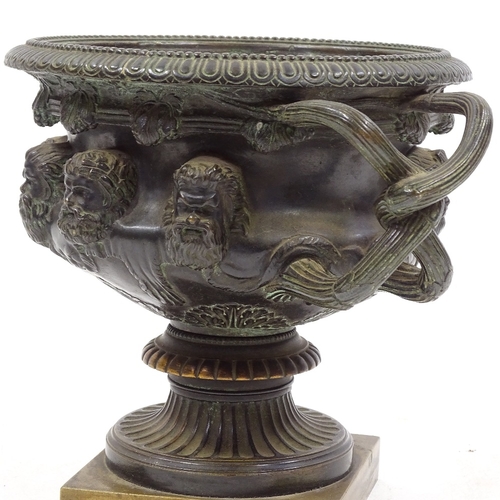 71 - A 19th century Classical design bronze 2-handled urn, decorated with relief cast masks and entwined ... 