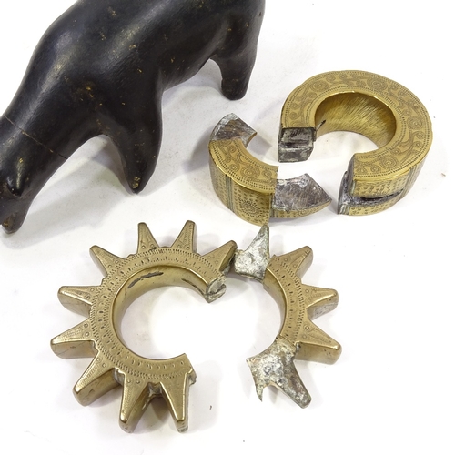 75 - An Inuit carved stone polar bear, length 22cm, and 2 unusual Middle Eastern bronze disc padlocks (3)