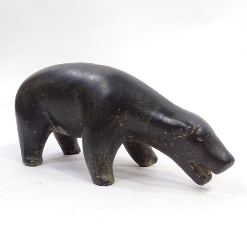 75 - An Inuit carved stone polar bear, length 22cm, and 2 unusual Middle Eastern bronze disc padlocks (3)