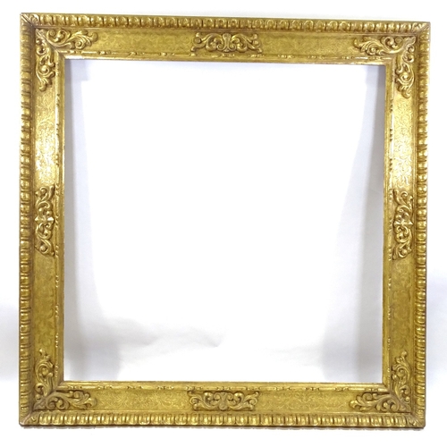 86 - A large 19th century relief carved giltwood mirror frame, 1.75m x 1.75m