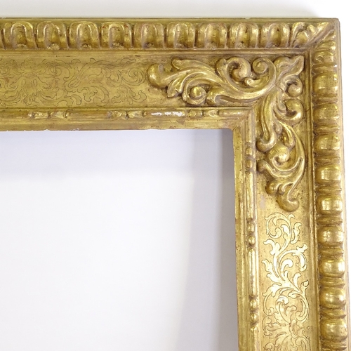 86 - A large 19th century relief carved giltwood mirror frame, 1.75m x 1.75m