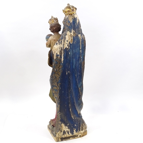 90 - A 19th century Italian carved painted and gilded wood and gesso figure of Mary and the infant Christ... 