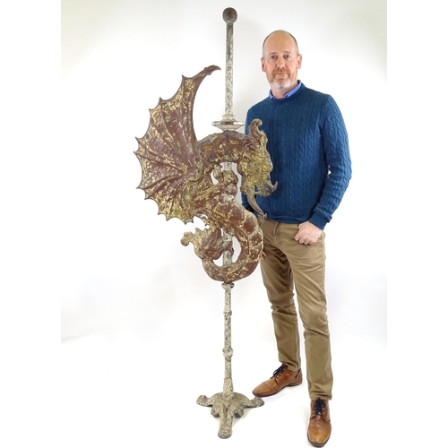 91 - A 19th century painted metal dragon design weather vane on cast-iron stand, overall height 1.94m