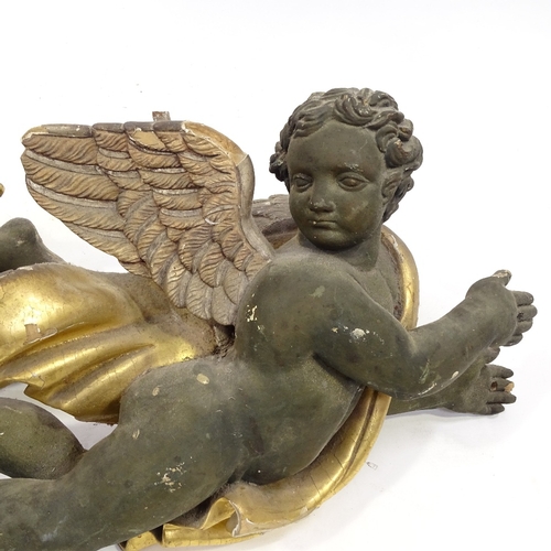 94 - A pair of 19th century carved painted and gilded wood flying cherub ornaments, length 68cm