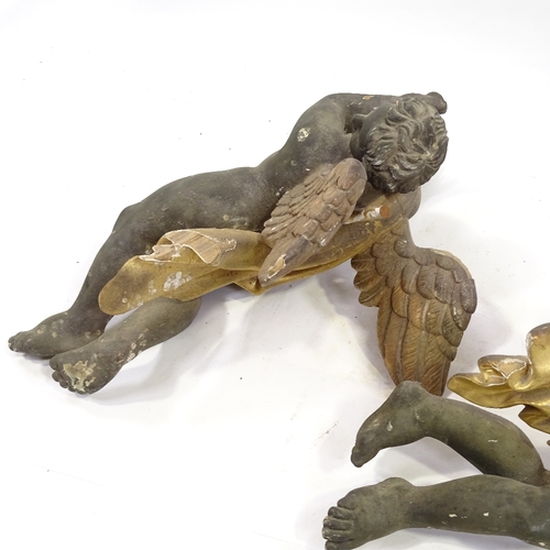 94 - A pair of 19th century carved painted and gilded wood flying cherub ornaments, length 68cm