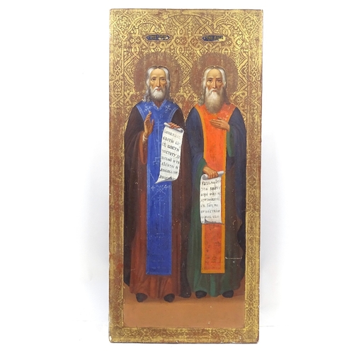 106 - A Russian painted and gilded icon, 18th or 19th century, depicting 2 saints with Cyrillic inscriptio... 