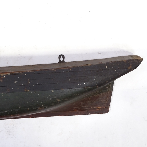 109 - A 19th century painted solid wood half boat hull, length 97cm