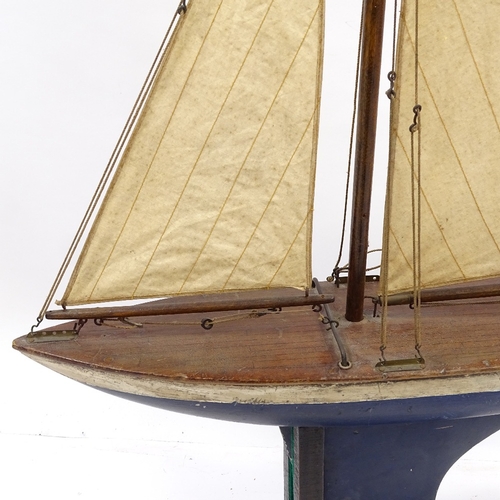 113 - A Victorian painted wood hulled model pond yacht, with sails and rigging, hull length 16cm, height 1... 