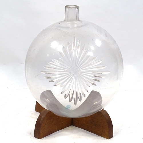 116 - A large Victorian blown glass Chemist's carboy with wheel-cut star emblem, on wooden stand, overall ... 