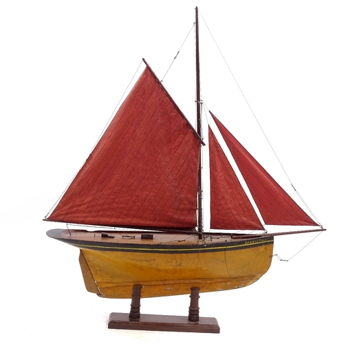 121 - A Victorian wooden hulled model pond yacht, with sails and rigging, hull length 72cm, on wood stand,... 