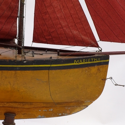 121 - A Victorian wooden hulled model pond yacht, with sails and rigging, hull length 72cm, on wood stand,... 