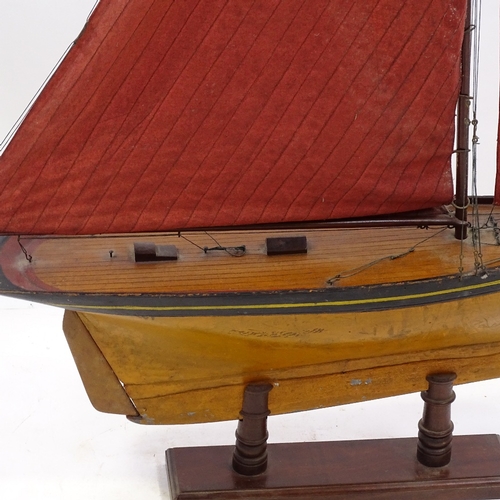 121 - A Victorian wooden hulled model pond yacht, with sails and rigging, hull length 72cm, on wood stand,... 