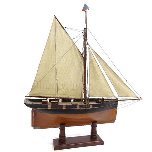 123 - A Victorian painted wood hulled model pond yacht, with sales and rigging, hull length 57cm, on woode... 