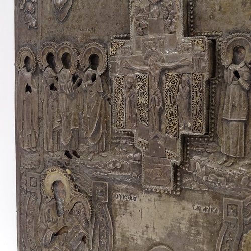 102 - A Russian silver-fronted icon, 18th or 19th century, relief moulded figures of the saints with Cyril... 