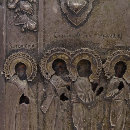 102 - A Russian silver-fronted icon, 18th or 19th century, relief moulded figures of the saints with Cyril... 