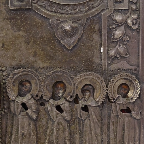 102 - A Russian silver-fronted icon, 18th or 19th century, relief moulded figures of the saints with Cyril... 