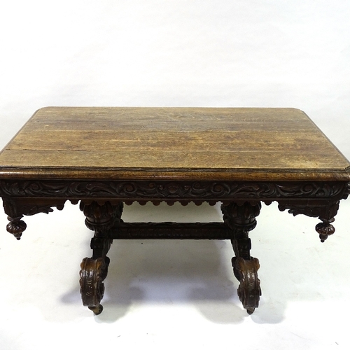 415 - A Victorian Carolean style oak library table, with end frieze drawers, raised on heavy carved scroll... 