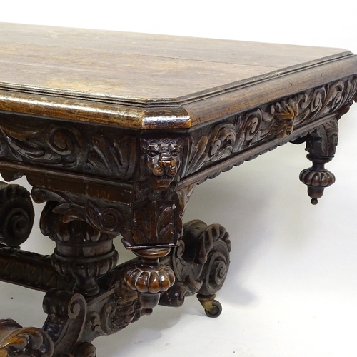 415 - A Victorian Carolean style oak library table, with end frieze drawers, raised on heavy carved scroll... 