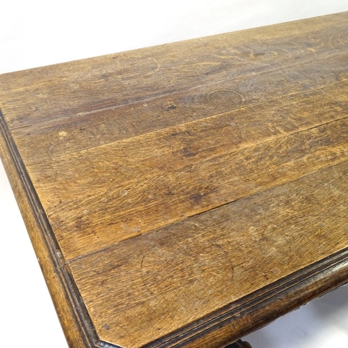 415 - A Victorian Carolean style oak library table, with end frieze drawers, raised on heavy carved scroll... 