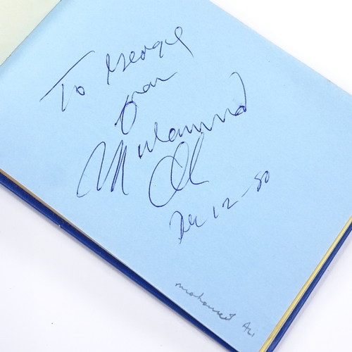 136 - An autograph book, including original signatures by Muhammad Ali, Gene Kelly, Charlton Heston, Barba... 