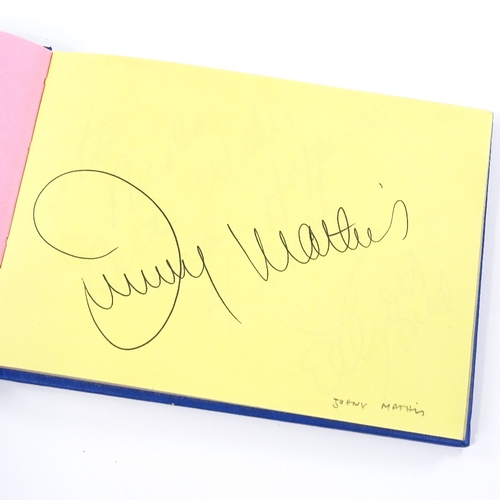 136 - An autograph book, including original signatures by Muhammad Ali, Gene Kelly, Charlton Heston, Barba... 