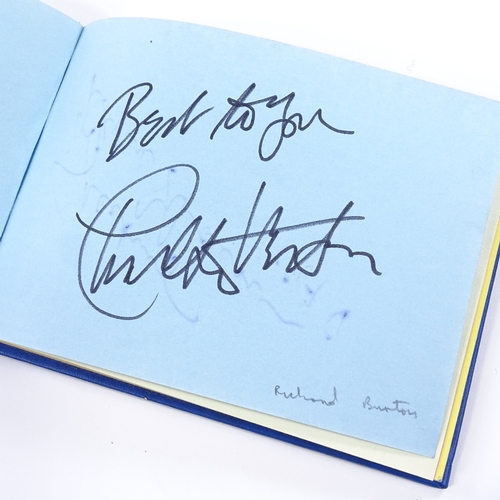 136 - An autograph book, including original signatures by Muhammad Ali, Gene Kelly, Charlton Heston, Barba... 