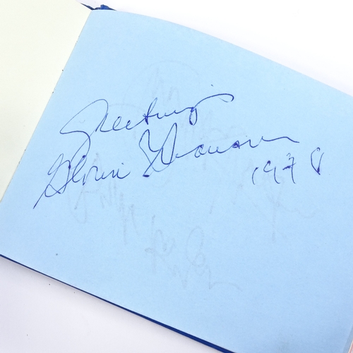 136 - An autograph book, including original signatures by Muhammad Ali, Gene Kelly, Charlton Heston, Barba... 