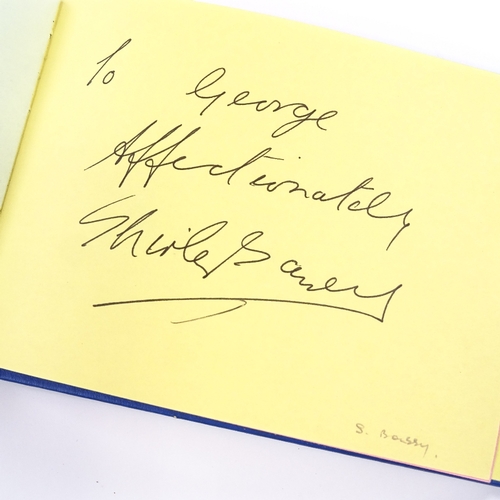 136 - An autograph book, including original signatures by Muhammad Ali, Gene Kelly, Charlton Heston, Barba... 