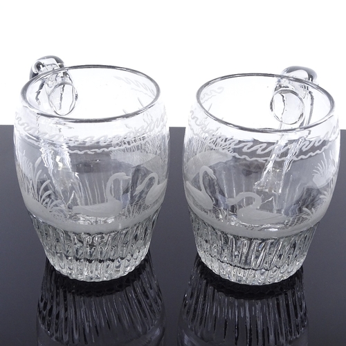 142 - A pair of 18th century glass barrel-shaped tankards, with wheel engraved swan designs, height 11cm