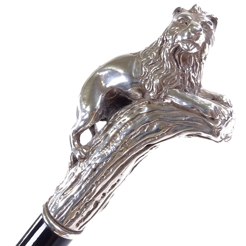 145 - A silver lion-handled walking stick, marked 925