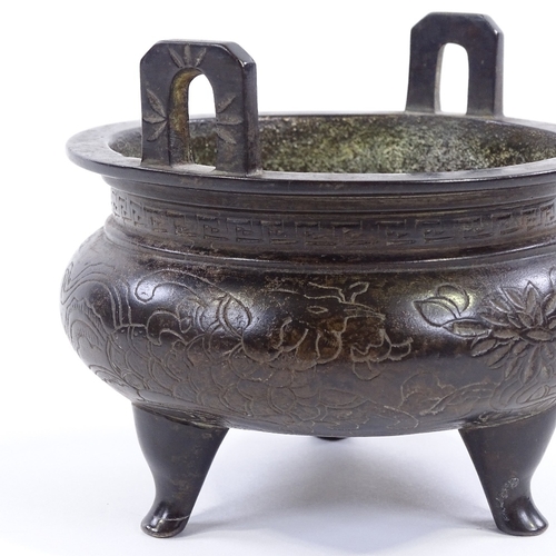 146 - A Chinese patinated bronze 2-handled Ding incense burner, with incised decoration and 6 character se... 