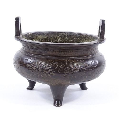 146 - A Chinese patinated bronze 2-handled Ding incense burner, with incised decoration and 6 character se... 