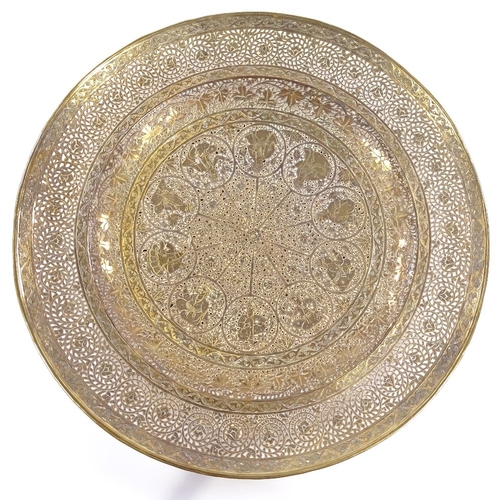 149 - An ornate Middle Eastern brass plate, with pierced and engraved decoration, diameter 23cm