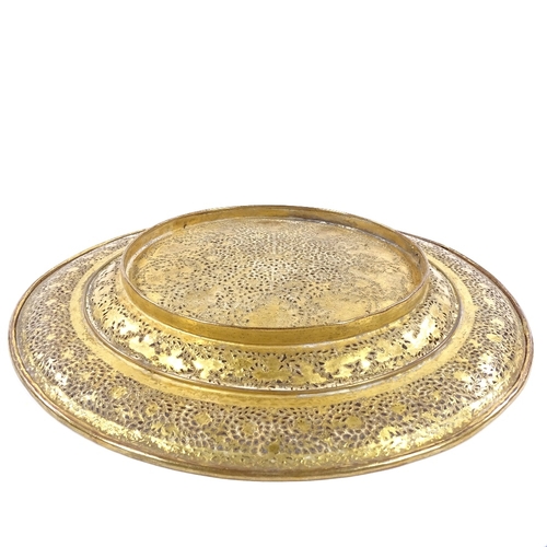 149 - An ornate Middle Eastern brass plate, with pierced and engraved decoration, diameter 23cm