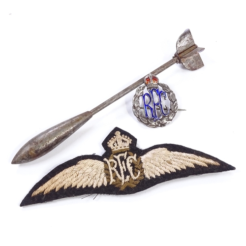 182 - A First War Period Flechette Dart (type 2), length 12cm, and an RFC wings badge, and a silver and en... 