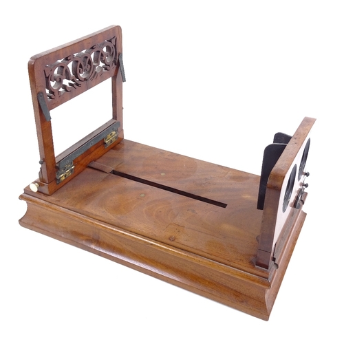 187 - A Victorian mahogany table-top stereoscopic card viewer, with pierced fretwork panel and ivory knobs... 