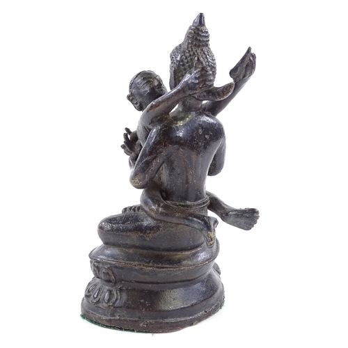 393 - An Indian bronze figure of Buddha holding a child, height 17cm