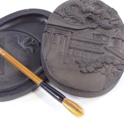 400 - A Chinese ink stone and cover, with relief moulded lid, length 14cm, and brush