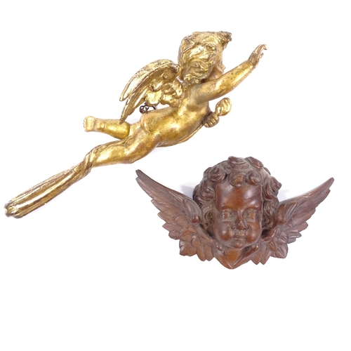 95 - A 19th century carved painted and gilded wood cherub ornament, length 52cm, and a 19th century carve... 