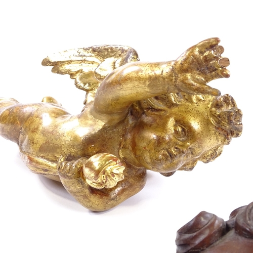 95 - A 19th century carved painted and gilded wood cherub ornament, length 52cm, and a 19th century carve... 