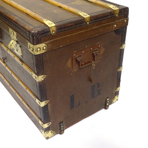 405 - An early wood leather and brass-bound travelling trunk by Moynat, original label inside lid, 90cm x ... 