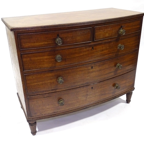 417 - A George III mahogany bow-front chest of drawers, original bras handles and turned feet, width 104cm