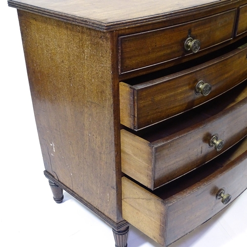 417 - A George III mahogany bow-front chest of drawers, original bras handles and turned feet, width 104cm