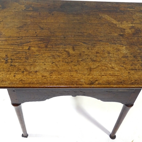 432 - An 18th century oak lowboy, with frieze drawer, turned legs and pad feet, width 79cm