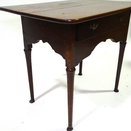 432 - An 18th century oak lowboy, with frieze drawer, turned legs and pad feet, width 79cm