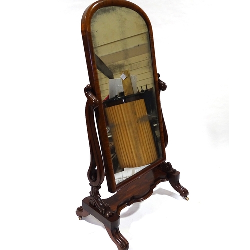 434 - A Victorian mahogany cheval mirror with arched top, on carved and scroll supports