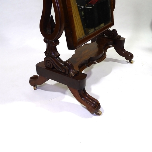 434 - A Victorian mahogany cheval mirror with arched top, on carved and scroll supports