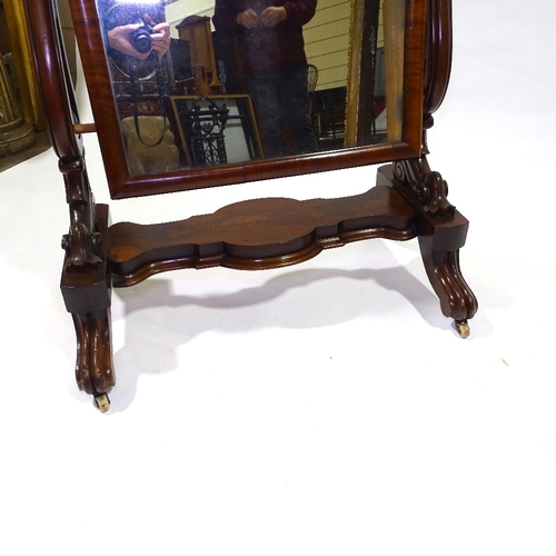 434 - A Victorian mahogany cheval mirror with arched top, on carved and scroll supports